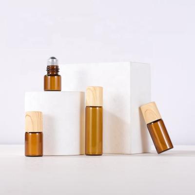 China Personal Care 1ml 2ml 3ml 5ml Amber Glass Roll On Bottle Essential Oil Sample Bottle Bamboo Cap Bottle for sale