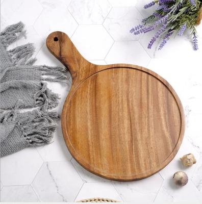 China Modern Solid Wood Wooden Snack Tray Round Handle Pizza Tray Acacia Round Wooden Cutting Board for sale