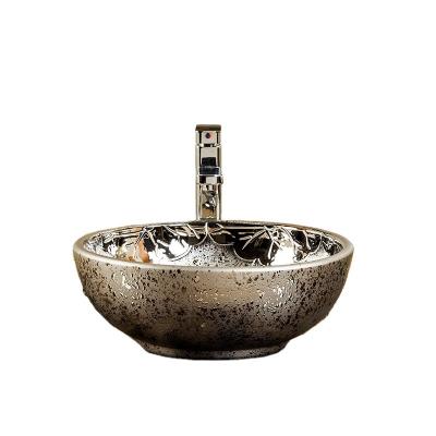 China Contemporary Hot Selling Plated Silver Carved Ceramic Bathroom Basin Basin Tabletop Art European Wash Basin Bathroom Sinks for sale