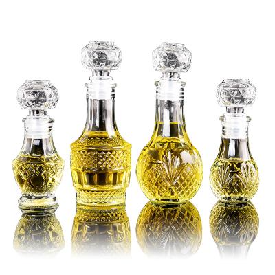 China 50ml luxury mini wine bottle carved crystal glass bottle whiskey alcohol fruit juice drink glass wine bottle with screw cap for sale