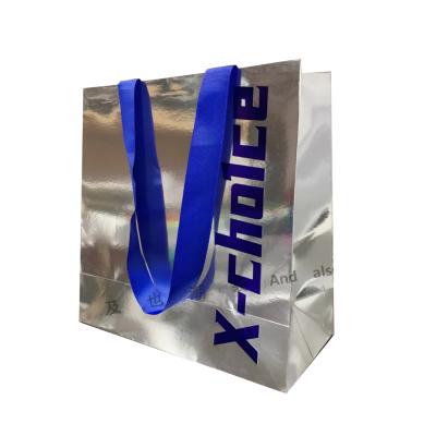 China Recyclable custom paper bag klein blue logo ribbon handle paper card shiny silver paper gift bag for sale