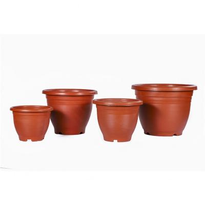 China Transitional Trendy White Plastic Flower Plant Pot With Holes Nursery Pots for sale