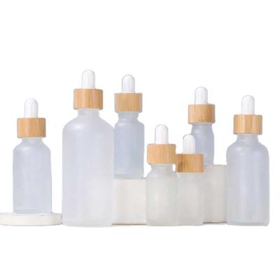 China 5ml~100ml Cosmetic Hair Essential Oil Bottles 30ml Cuticle Dropper Frosted Glass Bottle With Bamboo Lid Top For Cbd for sale