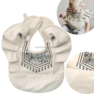 China Washable Tassels Printed PU Waterproof Gimlet Bib Cuddle Bibs Easy To Clean Apron With Crumbs Pocket For Kids Feeding Teething for sale