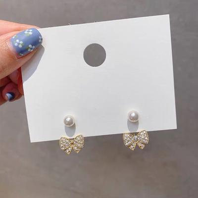 China Trendy Korean Two Small Bow Earrings Fashionable 925 Silver Diamond Needle Pearl Women's Earrings Jewelry for sale