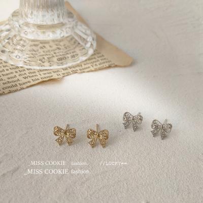 China Trendy Fashion Jewelry Store S925 Silver Needle Plated 14K Gold Mini Small Hollow Bow Stud Earrings Female for sale