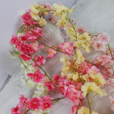 China Simple wedding hall engagement wedding flower decoration white flower vine backdrop engagement stage ornaments for sale