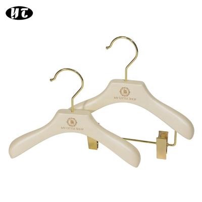 China SHOW Custom Kids Baby Clothes Hanger White Wooden Bead Hanger with Gold Hook and Gold Clips for sale