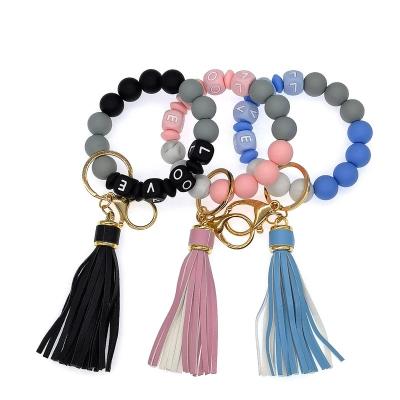 China Silicone Key Bean Keychain Wrist Bracelet Decoration LOVE Keychain for Handbag Door Car Key Holder Elastic Silicone Wristband Keyring for sale