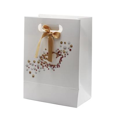 China Luxury High Quality Recyclable Accept Customized Logo Gift Carry Paper Shopping Bags With Bow Tie Ribbon for sale