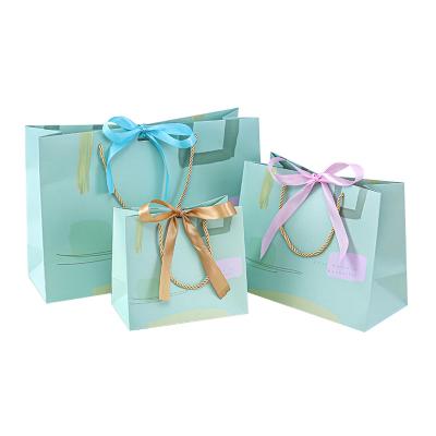 China Recyclable Apparel Jewelry Boutique Luxury Retail Customized Your Logo Gift Small Carry Paper Shopping Bag With Bow Tie Ribbon Handle for sale