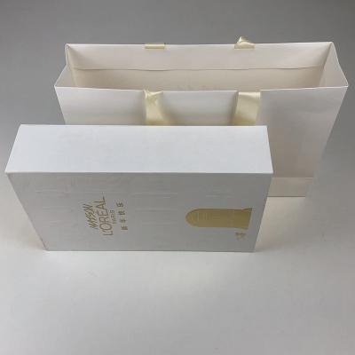 China Direct Selling Recycled Materials Low Price White Kraft Paper Clothes Paper Bag With Your Own Logo for sale