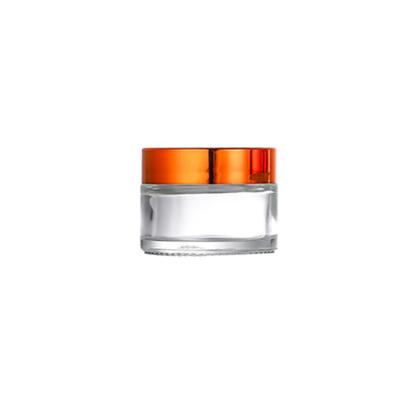 China Personal Care 30g Clear Skin Care Cosmetic Glass Jar With Gold Alu Cap For Face Cream for sale