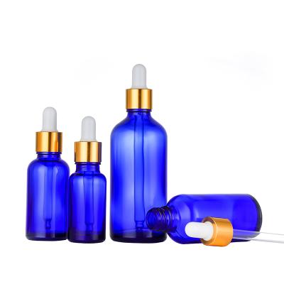 China New Product 10ml 15ml 30ml 50ml 100ml Cosmetic Luxury Blue Hair Oil Dropper Glass Bottle With Gold Dropper Cap for sale