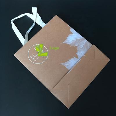 China 300g Handmade Top Selling Kraft Paper Gift Packaging Shopping Bags With Cotton Ribbon Handle for sale