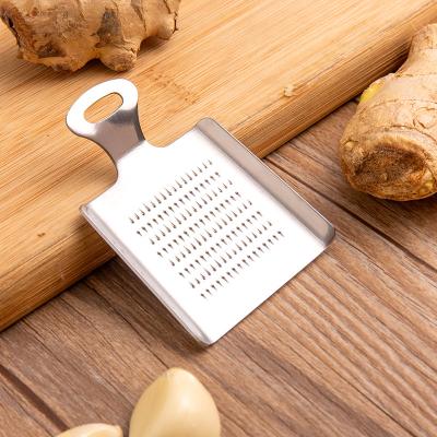 China Sustainable Practical Kitchen Mini Shovel Shaped Stainless Steel Plate Garlic Ginger Grater for sale