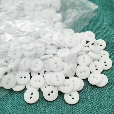 China Dry cleaning 18L 11.5mm 2 holes fish eye resin button with rim in matte white color, dyeable resin button for sale