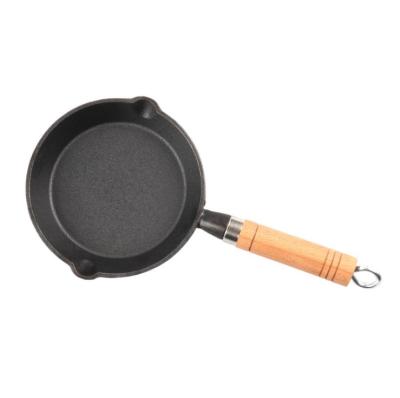 China Amazon Sustainable Hot Selling No Stick Cast Iron Frying Pan Cast Iron Cookware Cooking Skillet With Wooden Handle for sale