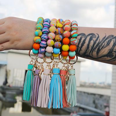 China Hot Selling Key Chain Ring Silicone Bracelet Keychain Wholesale BOHEMIA Tassel Wrist Support Custom Colorful Beaded Silicone Bracelet for sale