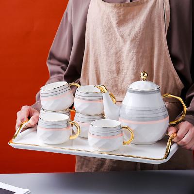 China Viable Home Luxury Teapot Afternoon Tea Set Cups Rim Handle Ceramic Tea Set Gold Color Creative Design With Tray for sale