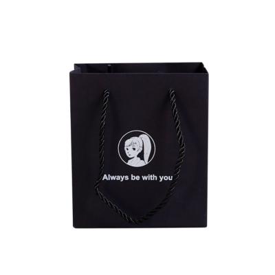 China Low MOQ high quality environment friendly logo paper package bag logo luxury brand customized paper handbag for clothing/shopping for sale