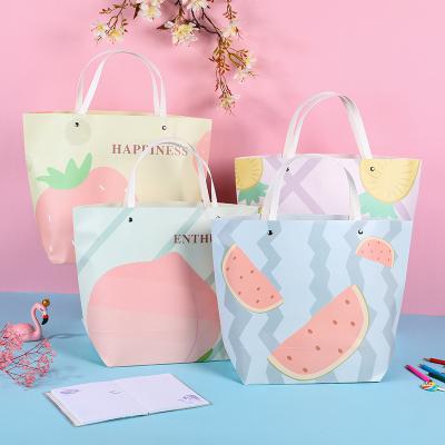 China 2021 Wholesale Recycled Materials Fashionable Stock Clothing Paper Bag With Handle Gift Paper Bag for sale