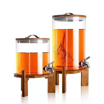 China Hot Stocked Borosilicate Drink Dispenser Juice Stocked Glass Jar With Lid Spit And Bamboo Holder for sale