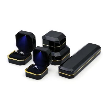 China Jewelry Packaging Irregular Shape Gold Frame Customize Logo Shiny Illuminated Black Jewelry Boxes With Led Light for sale