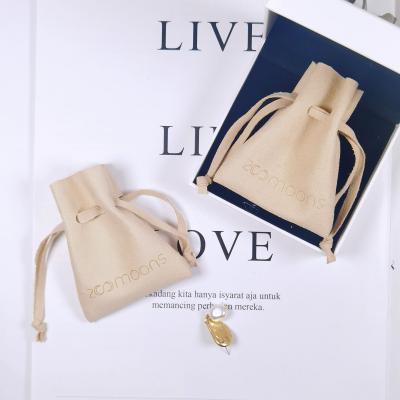 China Comfortable Package Feeling Microfiber Drawstring Jewelry Packaging Pouch Bag With Embossed Logo for sale