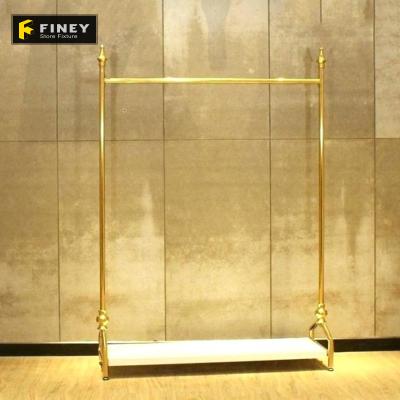 China Boutique fashion store supplies stainless steel hanger frame wooden floor display rack clothes brass display rack for sale