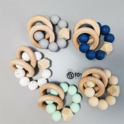 China Baby Gifts New Design Baby Sensory Teething Toys Click Soft Free Baby Teether Ring Kids Food Grade Silicone Bpa Beech Wood Teether for sale