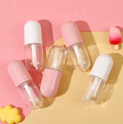 China Recycled Materials Wholesale Cute White Mini Pill Bottle Shape Lip Gloss Container Pink Lipstick Lip Gloss Packaging Tube With Brush 3ml for sale