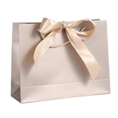 China Recycled Materials Gift Bags With Handles Bulk Waterproof Colorful Paper Bags With Bow Ribbon For Baby Shower Wedding Party Birthday Holiday for sale