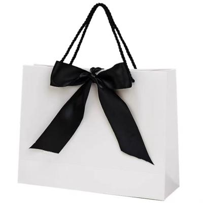 China Recycled Materials White Recyclable Luxury Gift Bags Thank You Gift Paper Bags With Black Bow Ribbon Gift Treat Boxes For Wedding for sale