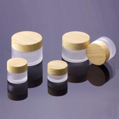 China Cosmetic Cream Frosted Glass Cosmetic Jars Bottle Vial Jar With Wooden Texture Plastic Lid Empty Cosmetic Refillable Face Cream for sale