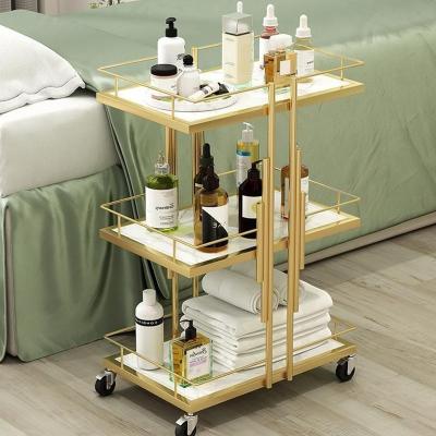 China Modern Modern Modern luxury Gold 3-floor bathroom shelf Cosmetics storage shelf Nail Salon Beauty salon trolley Salon beauty tram for sale