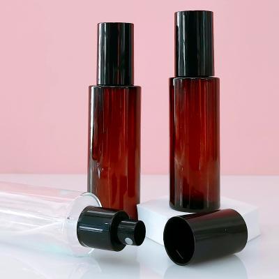 China 60ml 80ml Custom Luxury Cylinder Cosmetic Oil Bottle Toner Perfume Amber Glass Mist Spray Bottles With Black Sprayer for sale