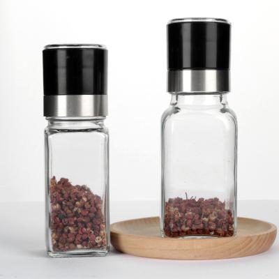 China Hot Selling Viable Hot Selling Manual Kitchen Salt And Pepper Square Spice Powder Glass Bottle Hand Grinder With Lid Grinder for sale