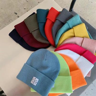 China COMMON Custom Knitted Soft Cute Knitted Winter Beanie Hat Letter Patch Hat Woolen Women Hat for sale