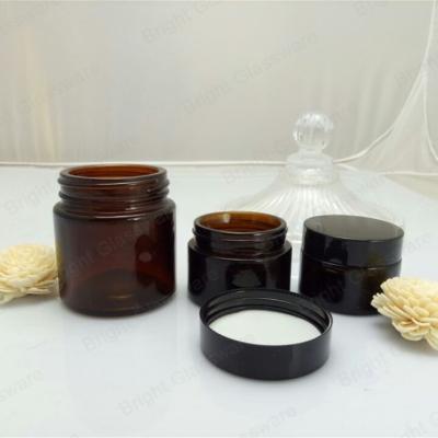 China Face cream amber glass jar with black plastic cap for sale