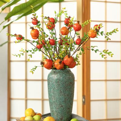 China Realistic Fake Moss Branch Artificial Pomegranate Fruit Fruit Decorative Implements For Garden Flower Decoration for sale