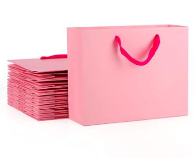 China Sturdy Pink Kraft Recyclable Goods Bags Handled Paper Shopping Goods Bags Decoration Homemade Paper Bags for sale