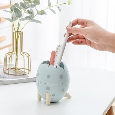 China Viable Hot Selling Desktop Dinosaur Makeup Egg Pen Holder Fashion Dinosaur Eggs Storage Creative Detachable Bucket Cartoon Brush Holder for sale