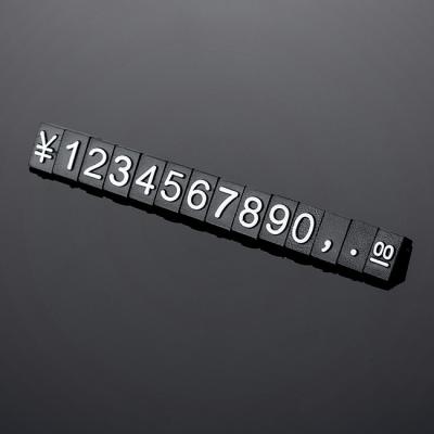 China 140 pcs The 5*3mm price cubes are made from black glossy plastic and have embossed white lettering for sale