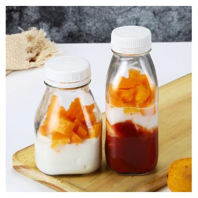 China Cold Pressed Beverage Bottle 250ml 300ml 500ml Clear French Square Glass Bottles With Plastic Screw Cap for sale