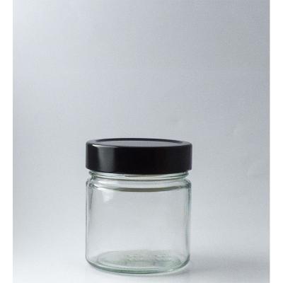 China Custom 212ML Food Round Wide Mouth Ergo Block Glass Honey Jar With Metal Hook Twist Lid for sale