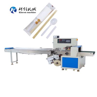 China Full Automatic Food Feeder Spoon Flow Wrapping Packaging Machine Towel Cutlery Pillow Roll Tissue Bag Facial Paper Packing Machine for sale