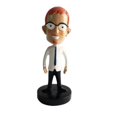 China 2021 New Europe Polyresin Young Boy Shake Comic Head With Glasses Shaking Japanese Head Doll Figurine for sale