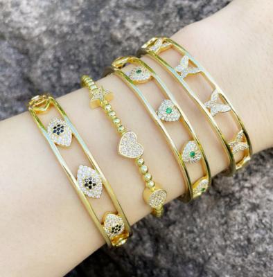 China Trendy Gold CZ Diamond Pave Smiley Planet Saturn Cross Hamsa Hand Evil Eyes, Lightning Double Layer Band Stacking Bangle Bracelet for sale