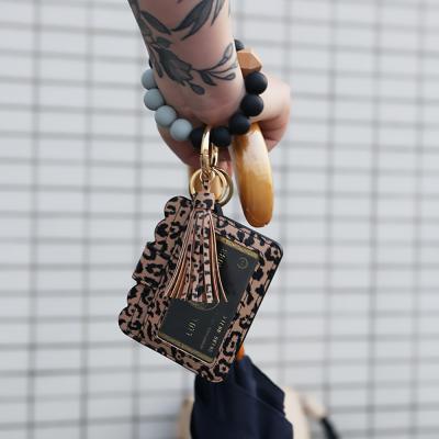 China PU+Silicone Beads Food Grade Silicone Beads Key Bracelet Ring With Wooden Bead And Wallet Women's Key Chain Bracelet With Tassel And Purse Fedex for sale